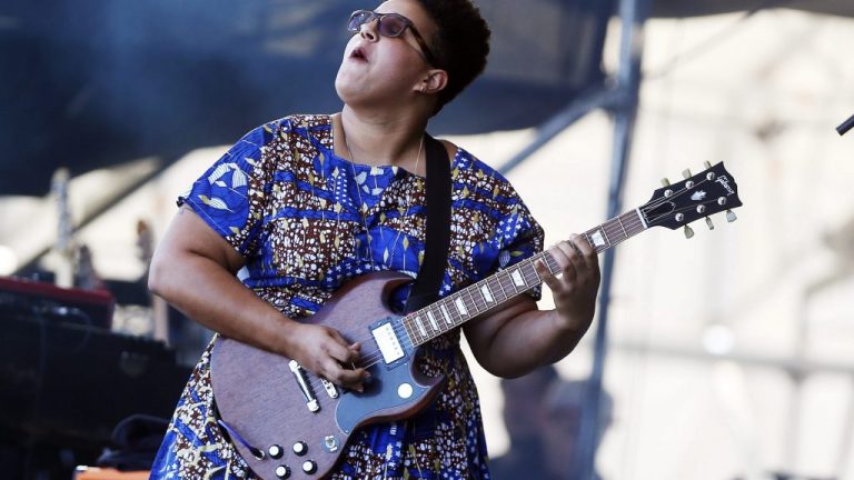 A photo of Brittany Howard playing her Gibson SG guitar